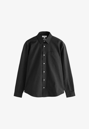 Melnā garo piedurkņu pogājamā krekls ar asu apkakli, priekšējo kabatu un baltām pogām. Izgatavots no viendabīga, gluda auduma.