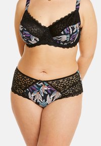 Soutien-gorge en dentelle noire avec des bonnets à motifs floraux, présentant des feuilles bleu vif, vert et violet. Un culotte noire rehaussée de dentelle complète l'ensemble.