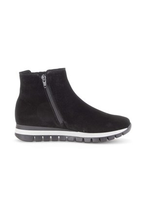 Black suede ankle boot with side zipper, white and gray sole, rounded toe, and textured pattern on the body for added grip and style.