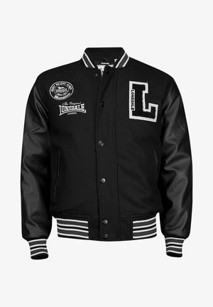 Black varsity jacket with leather sleeves, white embroidery, striped ribbed cuffs and waistband, featuring logo patches on front.