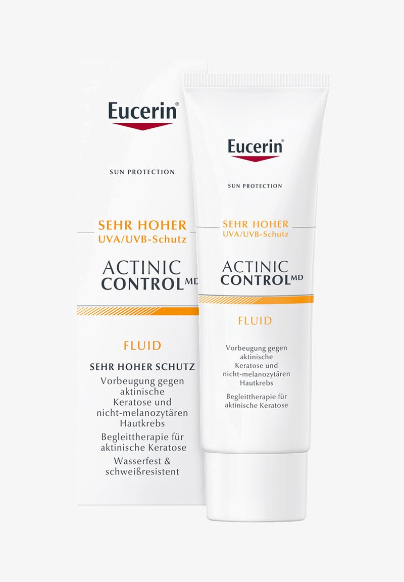Eucerin Actinic Control MD Fluid, weiße Tube mit Flip-Top-Verschluss, zeigt orange und schwarzen Text auf der Verpackung, der hohen Sonnenschutz betont.