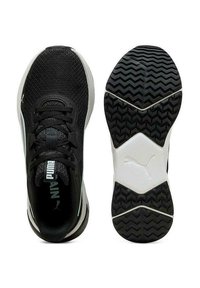 Zapatillas deportivas negras con parte superior de malla, suela de goma y textura en la suela. Presenta el logo de Puma en la lengüeta y el talón.