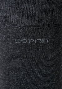 Schwarze Baumwollsocke mit geripptem Muster. Mit einem dezenten "Esprit"-Logo, das in den Stoff nahe der Oberseite eingewebt ist.