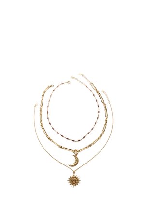 Gold necklace set with three layers: one with a crescent moon pendant, another with a sun pendant, and a beaded chain in between.