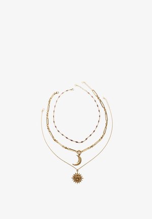 Gold necklace set with three layers: one with a crescent moon pendant, another with a sun pendant, and a beaded chain in between.