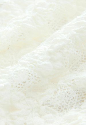 Delicate white lace fabric with intricate patterns and a soft, textured surface, featuring layered folds and a sheer appearance.