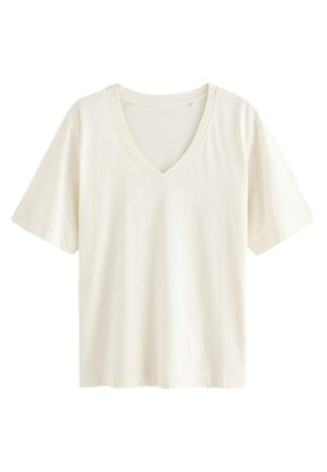 Fehér pamut póló V-nyakú kialakítással, rövid ujjakkal és laza szabással, sima textúrával és minták nélkül.