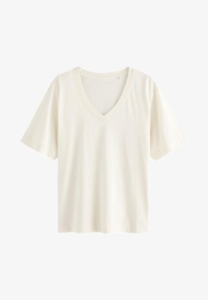 Fehér pamut póló V-nyakú kialakítással, rövid ujjakkal és laza szabással, sima textúrával és minták nélkül.