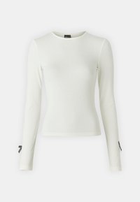 Maglietta bianca a maniche lunghe con girocollo, con dettagli in morbido fiocco neri sui polsini delle maniche. Tessuto liscio e design aderente.