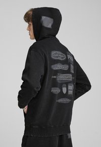 Puma SCUDERIA FERRARI DESERT   - Kapuutsiga pusa - black