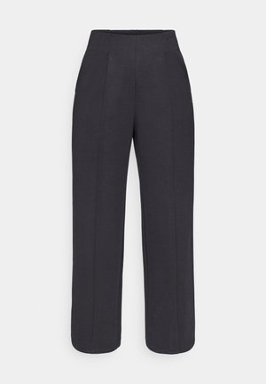 Pantalon noir à large jambe avec une taille haute et des détails plissés, confectionné dans un tissu lisse, présentant une silhouette épurée et ajustée.