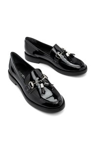 Black patent leather loafers with silver hardware accents and tassels, featuring a rounded toe and low, durable rubber sole.
