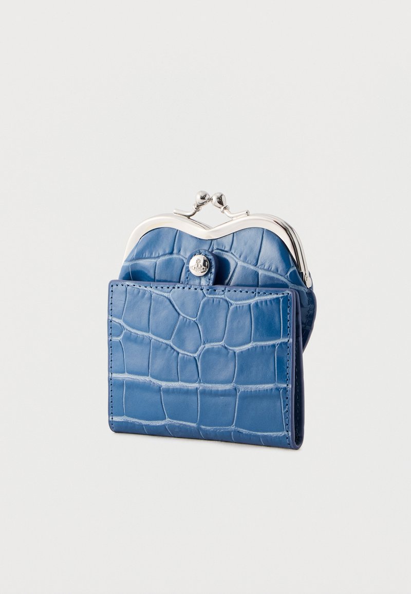 Small blue crocodile-pattern leather coin purse with silver clasp frame and front button pocket, standing upright on a white background.