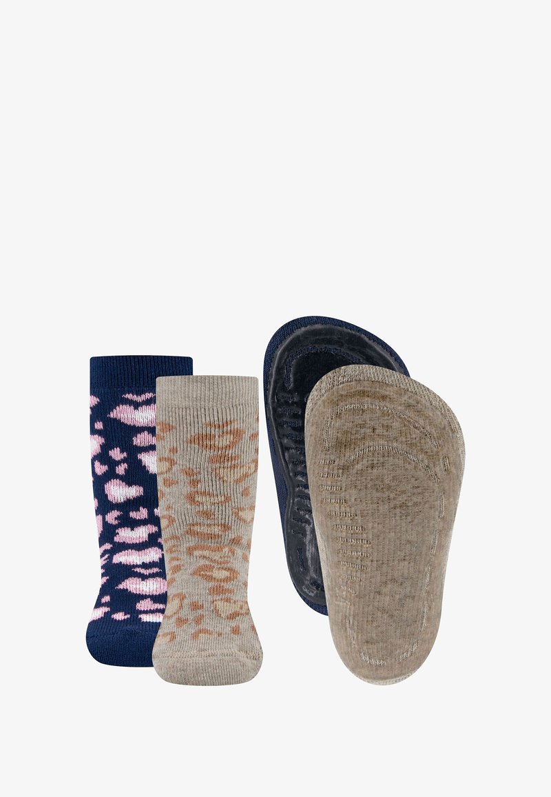 Two pairs of baby socks, one navy with pink spots and one beige with brown spots, shown from front and sole views.
