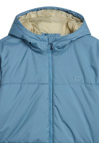 Light blue puffer jacket with a hood, featuring a front zipper and subtle logo. Inner lining is beige with a smooth texture.