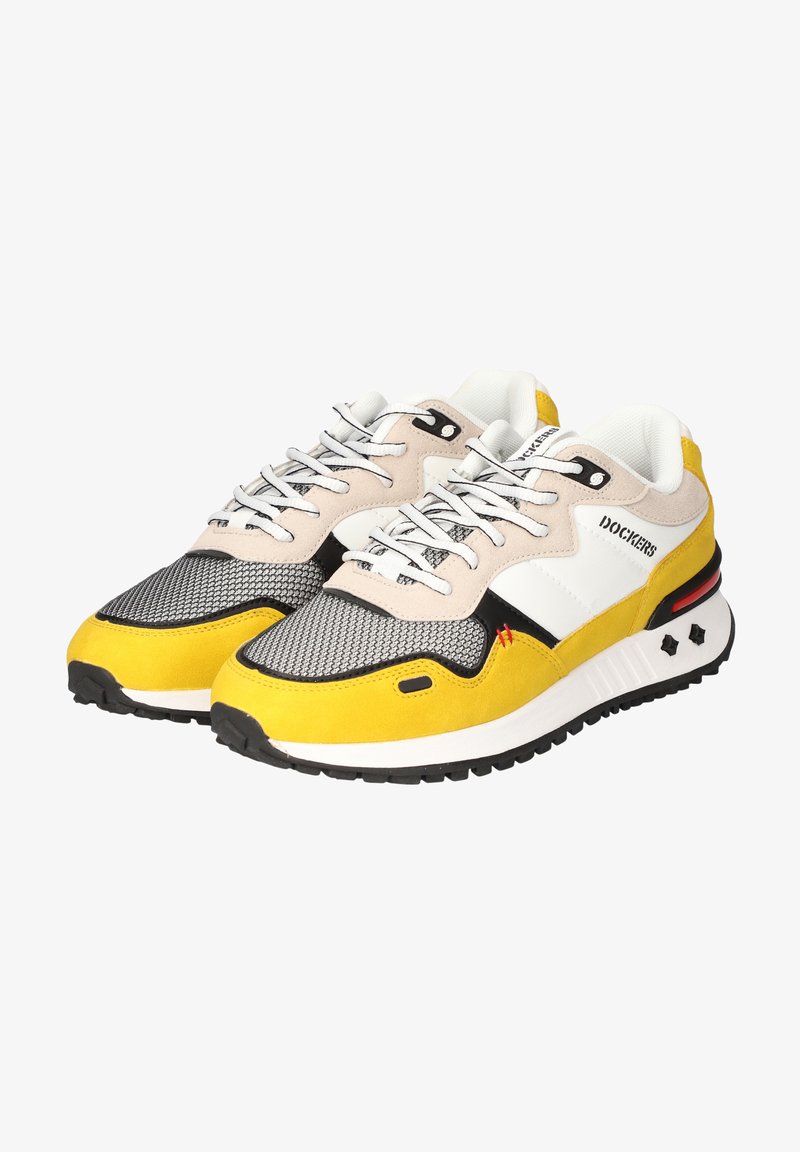 Gelbe und graue Sneakers mit einem Mesh-Obermaterial, Wildlederakzenten, schwarzen Details und weißen Gummisohlen. Die Schnürsenkel sind weiß mit zusätzlichem schwarzen Hardware.