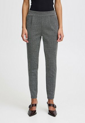 Gray herringbone pants with a tailored fit, side pockets, and a smooth texture, worn with black heeled shoes and a fitted top.