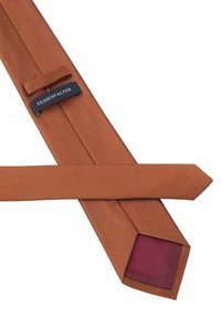 Brown striped tie with a smooth texture, featuring a dark label and a maroon inner lining. The tip is pointed and neatly cut.