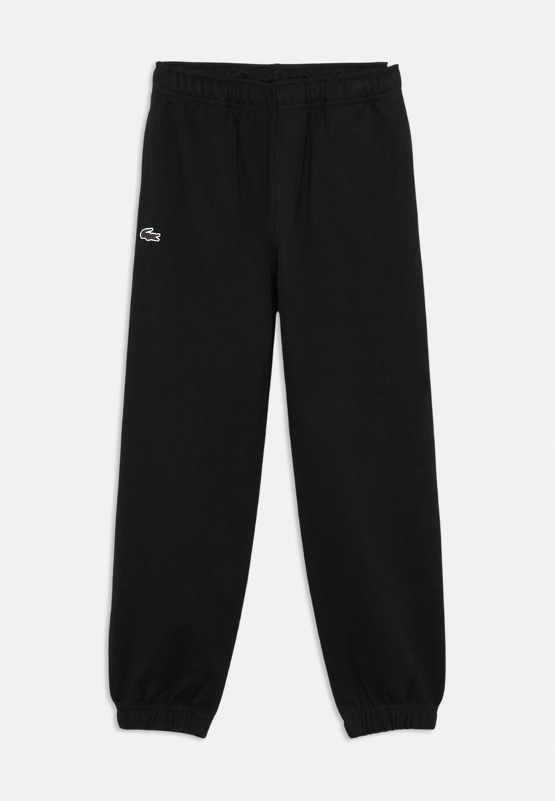 Pantalon de jogging noir avec taille élastique et bas de jambes resserrés, portant un petit logo crocodile blanc et noir sur la cuisse gauche.