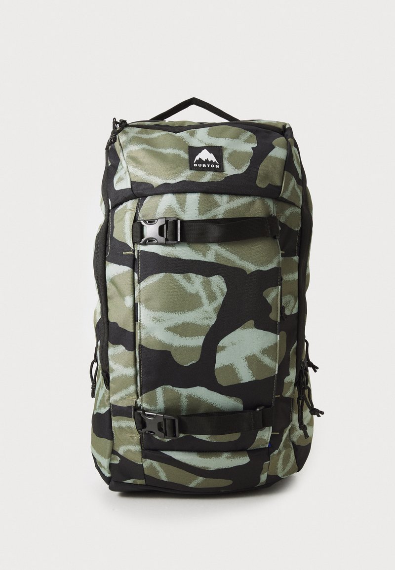 Large camo-patterned Burton backpack with black straps and buckles, featuring a top handle and front logo patch.