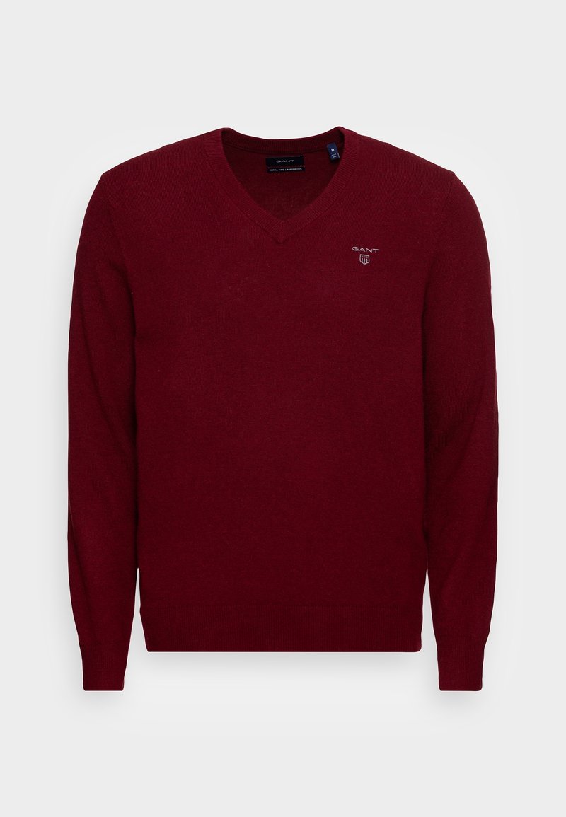 Pull en V maroon pour homme avec des manches longues, des poignets et un ourlet côtelés, arborant un petit logo blanc GANT sur la poitrine gauche.
