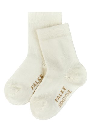 Cremfarbene Baumwollsocken mit glatter Textur. Sie besitzen einen gerippten Bund und die Aufschrift "FALKE SENSITIVE" in Hellbraun an der Seite.