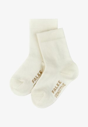 Cremfarbene Baumwollsocken mit glatter Textur. Sie besitzen einen gerippten Bund und die Aufschrift "FALKE SENSITIVE" in Hellbraun an der Seite.