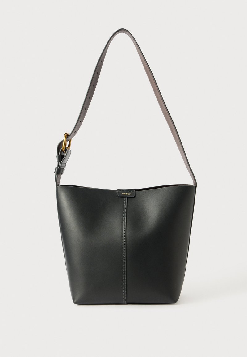 Bolso de hombro de cuero negro con una textura suave, forma curva y una sola correa ajustable que cuenta con herrajes dorados y un acento de marca.