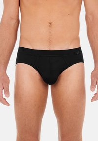 Schwarze Baumwollslips mit enganliegendem Schnitt, elastischem Bund und verstärkten Nähten. Minimalistisches Design ohne Muster oder Grafiken.