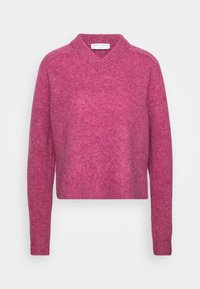 Rosa stickad tröja med v-ringning och långa ärmar. Texturerat tyg med en mjuk yta. Korts design framhäver formen och silhuetten.