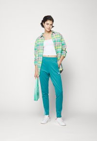 adidas Originals ADICOLOR SUPERSTAR TRACK - Spodnji deli trenirk - arctic fusion