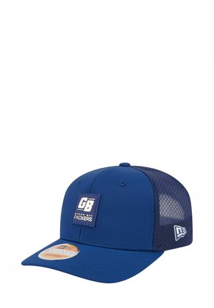 Blue baseball cap with flat brim and mesh back. Features a square patch labeled "GB" and "GREEN BAY PACKERS." Adjustable design.