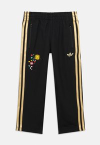 Μαύρο φόρμα παντελόνι με χρυσές ρίγες και κεντήματα με λουλούδια σε κίτρινες, ροζ και πράσινες αποχρώσεις. Ελαστική μέση και τσέπες με φερμουάρ.