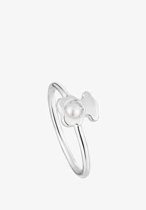 Silver ring featuring a flower design with a round pearl in the center. Smooth finish, thin band, and polished surface.
