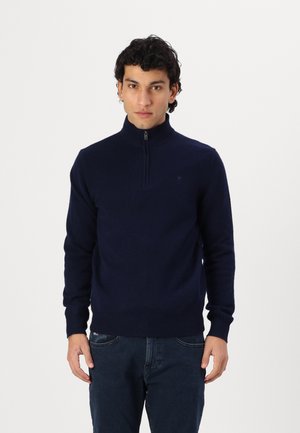 Dunkelblaues Reißverschluss-Sweatshirt aus weichem Strickmaterial mit hohem Kragen. Verfügt über gerippte Bündchen und Saum. Subtiler Logodetail auf der Brust.