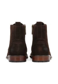Brown suede ankle boots with a smooth wooden heel, dual zippers on the sides, and subtle stitching detail at the back.