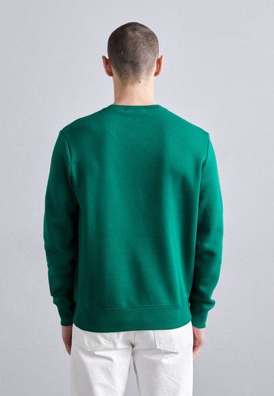 Sweat-shirt vert en mélange de coton, avec un col rond, des poignets côtelés et une texture lisse. Présenté de dos.