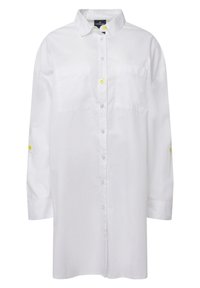 Camicia bianca con colletto, due tasche frontali e bottoni gialli a contrasto. Presenta maniche lunghe e una vestibilità ampia.