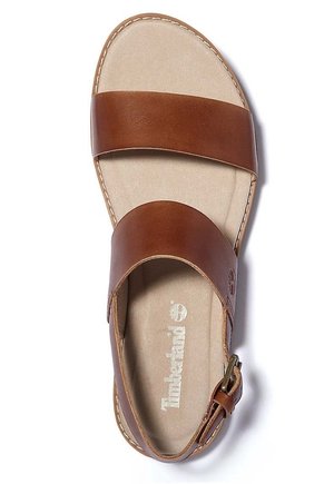 Brązowa skórzana sandał z dwiema szerokimi paskami, klamrą na pasku przy kostce oraz wyściełaną beżową wkładką z logo Timberland.
