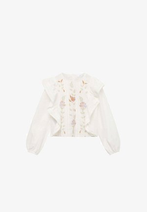 Blouse blanche avec des manches volantes et broderie florale dans des nuances de rose, orange et vert, présentant une coupe droite et un col rond.