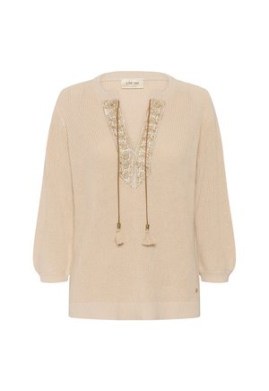 Cream-colored knit sweater with long sleeves, V-neck trimmed with gold embroidery, and hanging tassel ties.