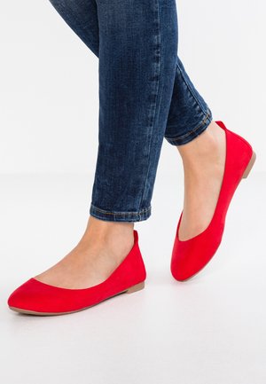 Red, suede ballet flats with a rounded toe and low, flat heel. The design features a slip-on style with no visible hardware or embellishments.
