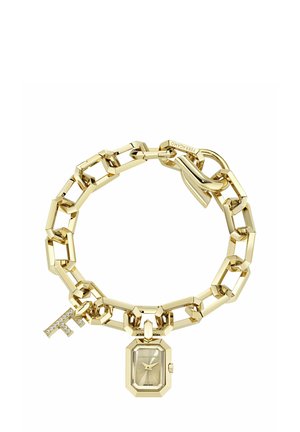 Zelta saitamā aprobe ar mazu astoņstūrainu pulksteņa seju un kristāliem rotātu "F" piekariņu, kas aizveras ar pogas tipa sprādzi.