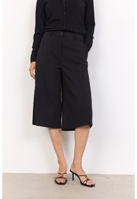 Black cropped wide-leg trousers with a high waist, featuring belt loops and front pockets, paired with black strappy high-heeled sandals.