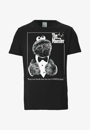 Black cotton t-shirt featuring a furry character in a tuxedo, with the text "The Monster" and a quote underneath in white.