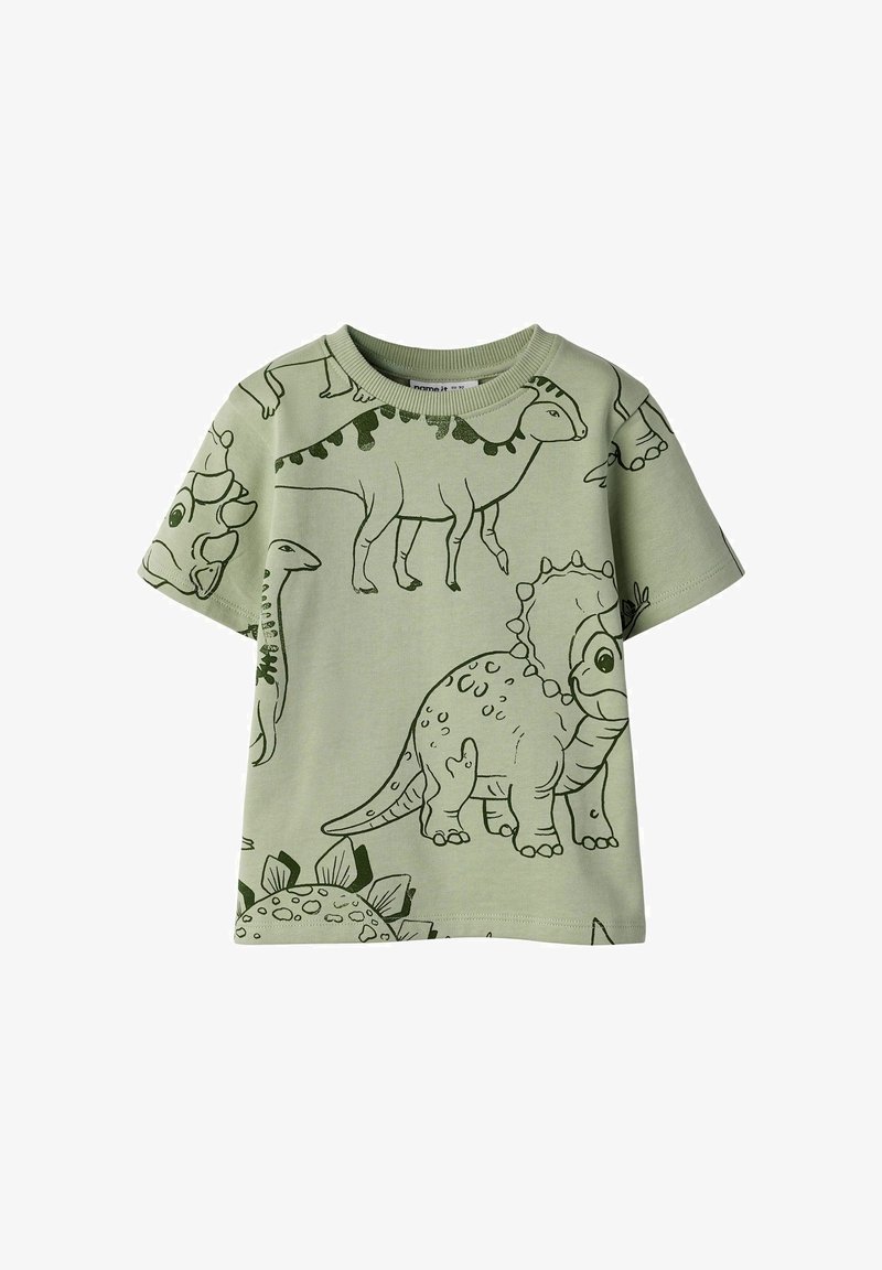 T-shirt enfant vert clair avec des dinosaures dessinés en style cartoon, contours verts foncés, imprimés en différentes poses sur tout le vêtement.