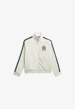 Weißer Zip-Jacke mit grünen Schulterstreifen und Logo. Sie hat einen hohen Kragen, zwei Fronttaschen und gerippte Bündchen. Weiche, glatte Textur.