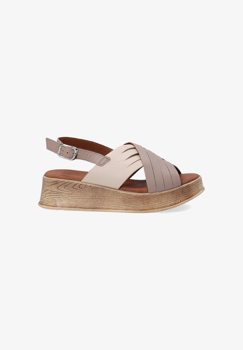 Beige leather sandal with a wide footbed, adjustable ankle strap, and a textured, platform sole featuring a wood-like pattern.