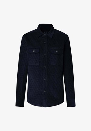 Camicia imbottita blu con due tasche sul petto, chiusura con bottoni e colletto. Realizzata in tessuto testurizzato con motivo a rombi. Maniche lunghe.