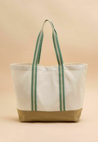 Borsa tote in tela con manici a righe verdi e crema, fondo beige, forma rettangolare e texture morbida. Ideale per un uso casual.